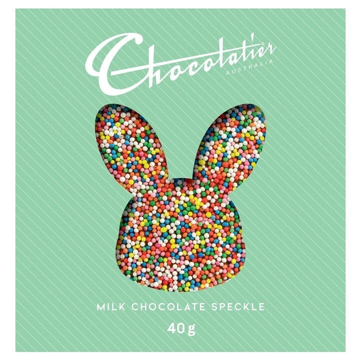 Chocolate bunny with colorful speckles on a green box with 'Chocolaties' branding.