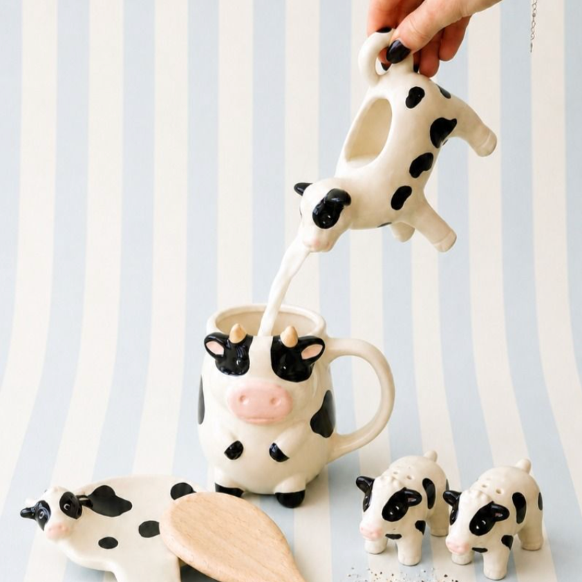 Urban Products Cow Mug with matching cow-shaped creamer jug pouring milk