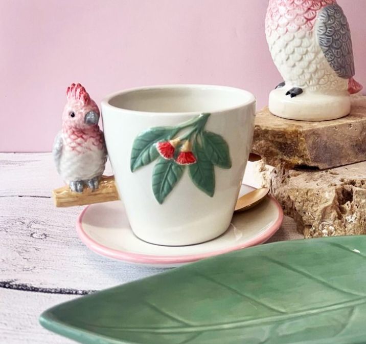 Urban Products Rosie Tea Cup & Saucer styled with matching cockatoo-themed kitchenware